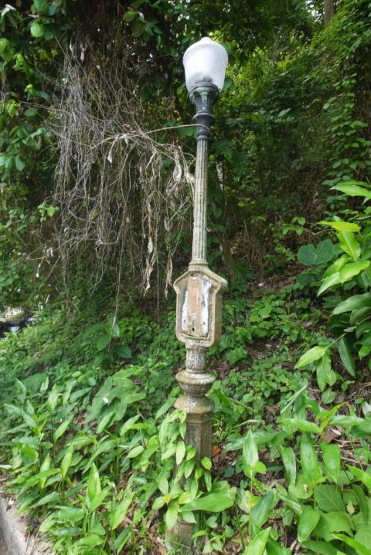 Yesteryear's neglected steet lamp, with a stolen and forgotten marker. Quite the post-colonial statement.